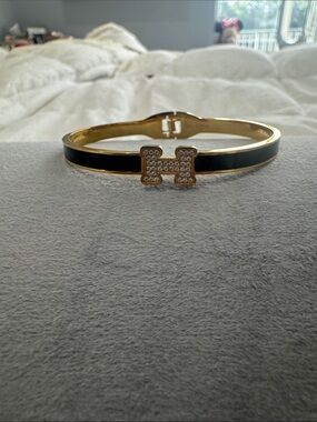 Gold Tone Black Enamel Bangle Bracelet with Crystal H Accent